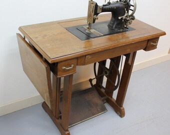 Vesta treadmill sewing machine on the table. With cast iron step mechanism