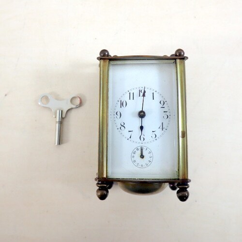 Antique shops travel clock with alarm function. Bronze fixture.