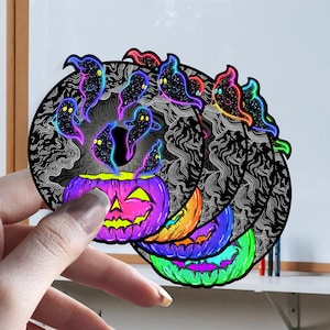 May include: A set of four Halloween-themed stickers featuring a jack-o'-lantern with glowing ghosts inside. The stickers are layered and have a rainbow color scheme.
