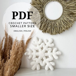 May include: PDF crochet pattern for a smaller size snowflake, written in English and Polish. The pattern features a white crocheted snowflake on a white background.