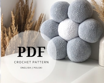 May include: A cluster of crocheted spheres in shades of gray and white, arranged in a flower-like pattern. The image features a soft, textured design, with the text "PDF CROCHET PATTERN ENGLISH / POLSKI" overlaid on the image.