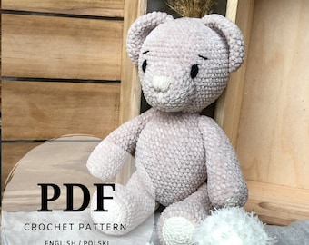 May include: A crochet pattern for a plush pink teddy bear with white pom-poms on its feet. The pattern is available in PDF format and includes instructions in both English and Polish.