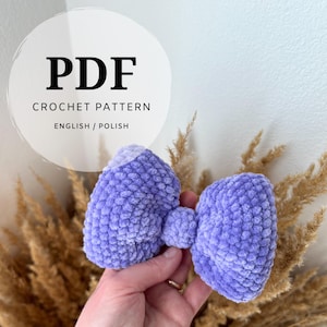 May include: PDF crochet pattern for a purple bow, written in English and Polish.