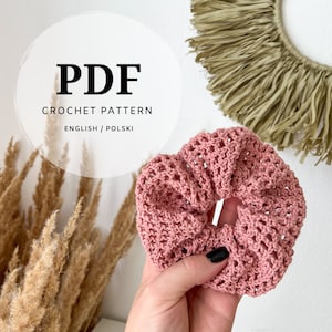 May include: A pink crocheted hair scrunchie with a delicate openwork pattern. PDF crochet pattern included in English and Polish.