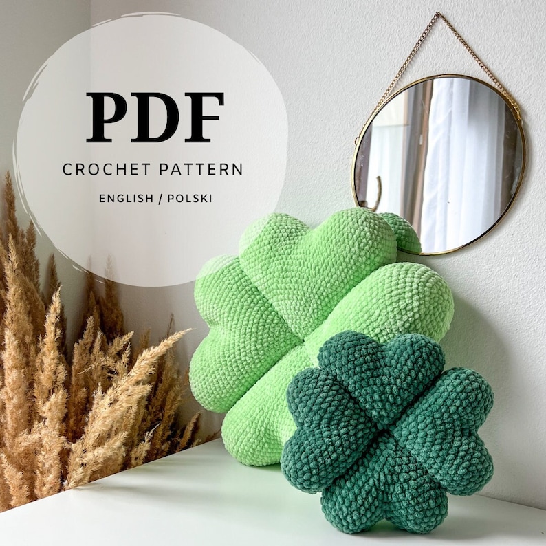 May include: PDF crochet pattern for a green four-leaf clover pillow. The pattern is available in English and Polish.