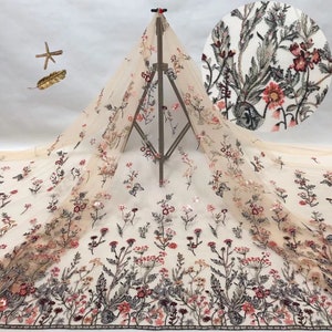 May include: Beige tulle fabric with embroidered floral designs in shades of pink, red, and green. The fabric is embellished with sequins.
