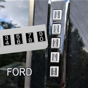 May include: Close-up of a black Ford vehicle door keypad with white numbers. A sticker with the numbers 1-2, 3-4, 5-6, 7-8, and 9-0 is next to the keypad. The word "FORD" is at the bottom.