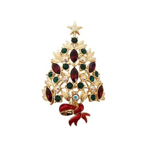 May include: Gold-coloured Christmas tree brooch with red, green, and iridescent gemstones. The brooch has a star at the top and a red bow at the base. A festive accessory for the holiday season.