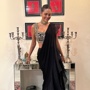 Bollywood Actress Esha Gupta  Black Blouse With Gold Handwork With Drape Ruffle Organza Saree Wear On Any Occasions And Looking Gorgeous.