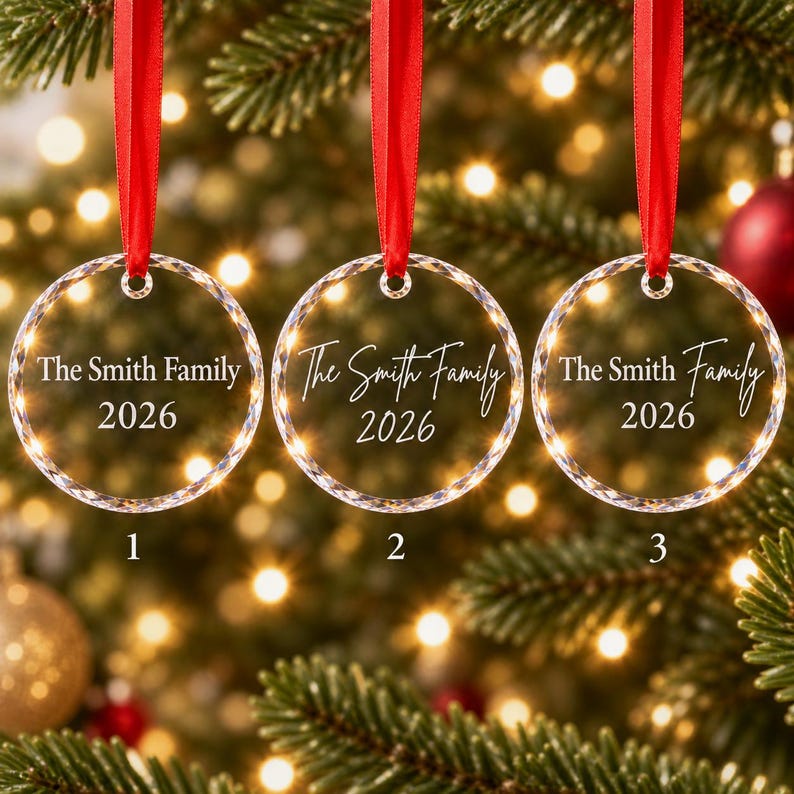 Three personalised engraved glass family Christmas baubles showing font options 1 block, 2 script and 3 mixed, each reading The Smith Family 2026
