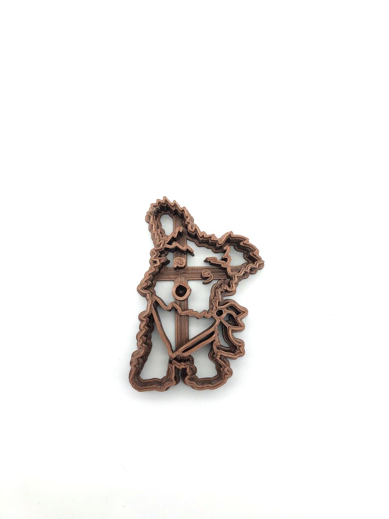 May include: A brown 3D printed cookie cutter shaped like a koala bear.