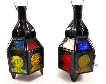 May include: Two black metal lanterns with colorful glass panels. The lanterns have a traditional Moroccan design and are perfect for adding a touch of elegance to any home.