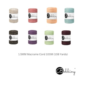 May include: Eight spools of 1.5 mm macrame cord in various colors, including natural, pink, peach, teal, brown, purple, green, and burgundy. Each spool is labeled "Bobbiny". The text "1.5MM Macrame Cord 100M (108 Yards)" is printed below the spools. The Bobbiny logo is printed below the text.
