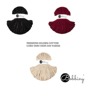 May include: Three skeins of cotton cord, each in a different color: black, red, and beige. The cord is 5mm thick and 100m (108 yards) long. The skeins are labeled "Bobbiny".