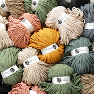 May include: A variety of colors of cotton rope, each wound into a ball. The rope is labeled with the brand name "Bobbiny".