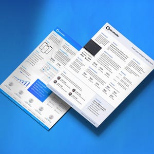 May include: Two white business reports with blue and black accents are displayed on a blue surface. The reports feature charts, graphs, and text, including the company logo and the word "placeholder". The reports are angled, creating a dynamic composition.