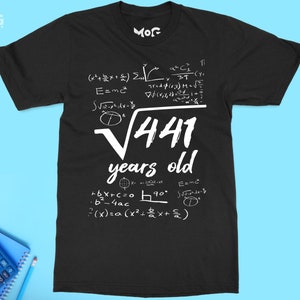 May include: Black t-shirt with white text and mathematical equations. The text reads "√441 years old".