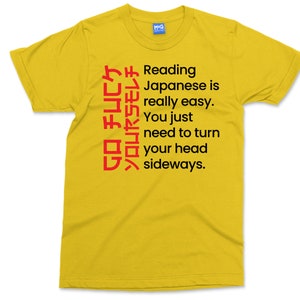 May include: Yellow t-shirt with black text that reads "Reading Japanese is really easy. You just need to turn your head sideways." and red Japanese characters.