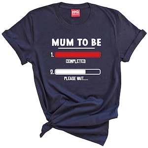 May include: Navy blue t-shirt with the text "MUM TO BE" and a progress bar graphic. The progress bar is labeled "1. COMPLETED" and "2. PLEASE WAIT..."