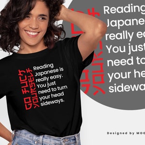 May include: Black t-shirt with white text that reads "Reading Japanese is really easy. You just need to turn your head sideways."  The text is written vertically in Japanese characters on the left side of the shirt.