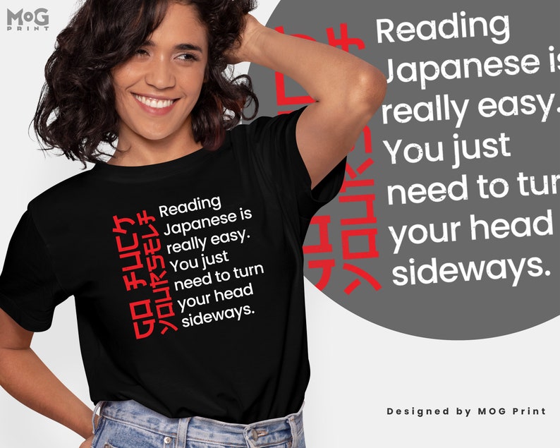May include: Black t-shirt with white text that reads "Reading Japanese is really easy. You just need to turn your head sideways."  The text is written vertically in Japanese characters on the left side of the shirt.