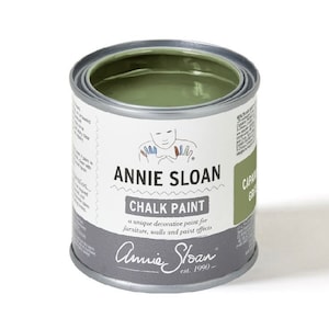 May include: A round metal tin of Annie Sloan Chalk Paint in the colour 'Caparol Green'. The tin has a white label with the Annie Sloan logo and the text 'Chalk Paint' and 'a unique decorative paint for furniture, walls and paint effects'.
