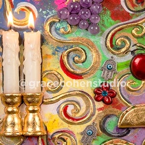 May include: An artistic composition featuring two lit candles in gold candle holders, red cherries, purple grapes, and decorative charms. The background is a vibrant mix of colors and swirling gold accents, with the text "@gracebonenstudio".