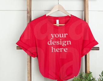 May include: Red t-shirt hanging on a wooden ladder with the text "your design here" printed on the front.