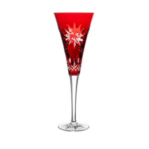 May include: A red crystal champagne flute with a starburst design.