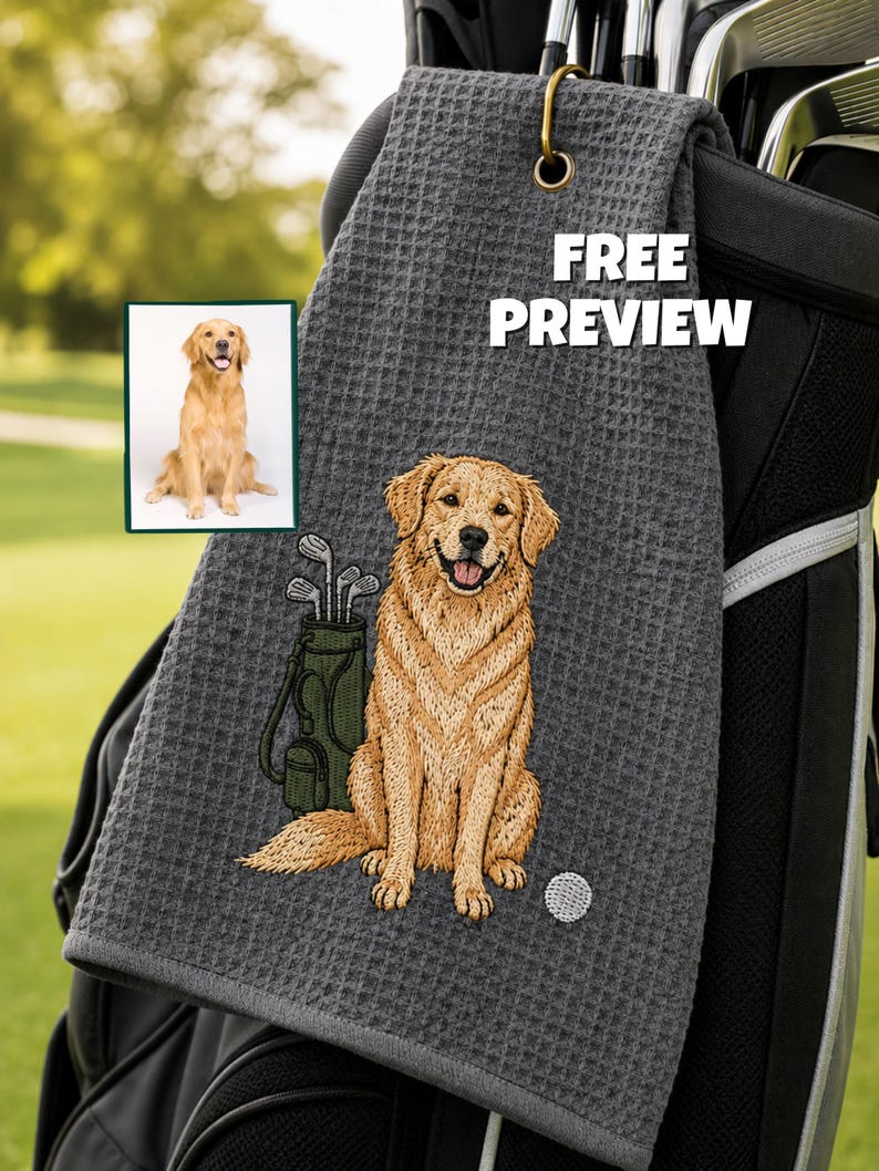 K&ouml;nnte beinhalten: Graues Golfhandtuch mit einem gestickten Golden Retriever, einer Golftasche und einem Golfball. Das Handtuch hat eine Waffelstruktur und einen goldfarbenen Haken. Der Text auf dem Handtuch lautet "FREE PREVIEW".