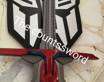 May include: A gray and red sword with a detailed hilt and crossguard, set against a black and silver emblem. The text "The countssword" is visible on the image. The sword has a futuristic design.