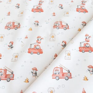 Könnte beinhalten: Weißer Stoff mit einem sich wiederholenden Muster aus Pinguinen, die Feuerwehrhelme tragen und rote Feuerwehrautos fahren. Das Muster enthält auch kleine Hydranten, Häuser und Flammen.