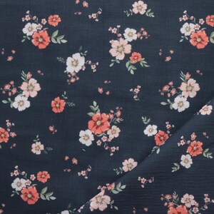 May include: Dark blue fabric with a white and pink floral pattern. The flowers are small and scattered across the fabric.