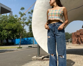 The Petal Top Checks is a handwoven Pastel cotton top with delicate checks symbolizing joy and connection to nature, and whimsical charm.