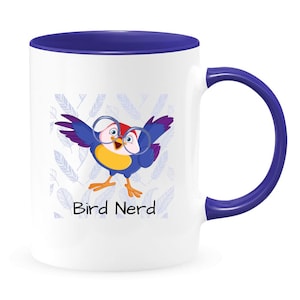 May include: White ceramic mug with a blue rim and handle. The mug features a cartoon bird wearing glasses and the text "Bird Nerd".