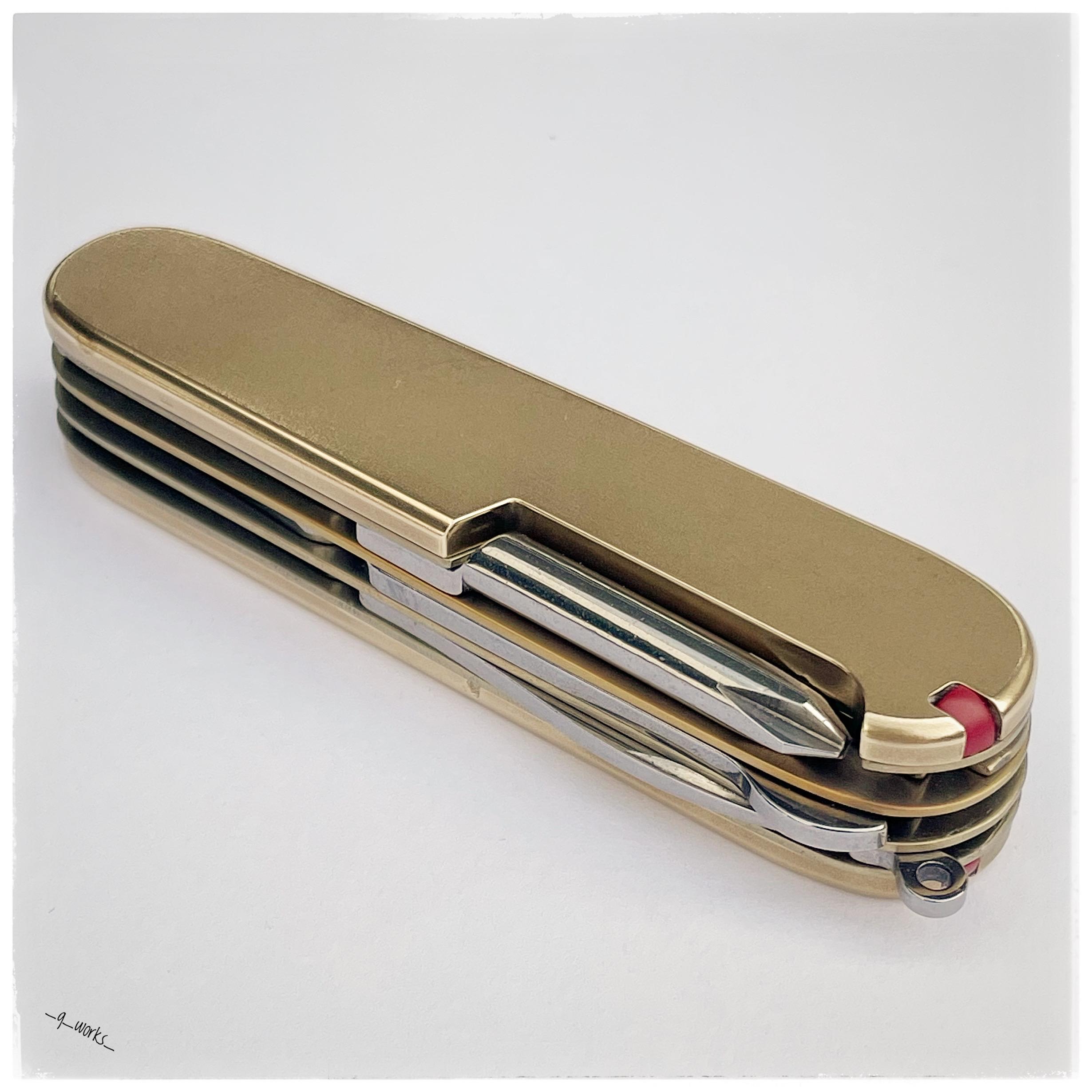 Custom modified Victorinox 91 mm Super Tinker with yellow titanium liners and brass scales.