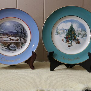 Set of 2 Avon Christmas Plates. 1979 &quot;Dashing Through the Snow, and 1978 Trimming the Tree&quot; 8.5inches Across