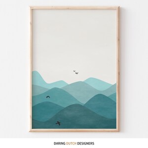 May include: Abstract art print featuring a blue and teal mountain landscape with black birds flying over the peaks. The print is framed in a light wood frame.