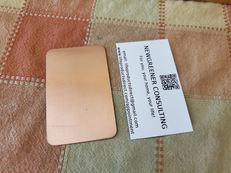 May include: A white business card with the text "NEWGREENER CONSULTING" and a QR code. The text below the company name reads "For you, your home, your life!" and includes contact information.
