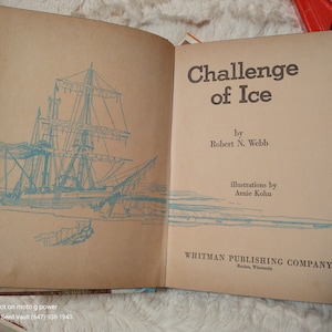 May include: A vintage book titled "Challenge of Ice" by Robert N. Webb, illustrated by Arnie Kohn. The book cover features a blue and white illustration of a ship sailing through icy waters.