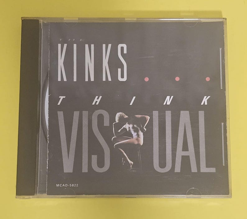 Op de afbeelding: Een zwart-witte CD-hoes met de tekst "KINKS THINK VISUAL" en de albumtitel "MCAD-5822".