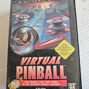 May include: A black Virtual Pinball video game case. The cover features a futuristic pinball machine design with red and white elements, a large pinball, and the game's title in bold, red letters. The Electronic Arts logo is at the top.