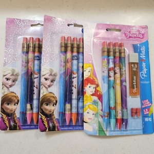 Op de afbeelding: Drie pakken Disney Princess mechanische potloden. Elk pak bevat potloden met afbeeldingen van Disney-prinsessen, waaronder Elsa en Anna. De potloden worden verkocht met een Paper Mate gum en vullingen.