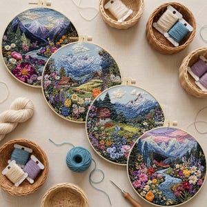May include: Four round embroidery hoops with detailed landscape scenes of mountains, rivers, and flowers. The hoops are displayed with spools of thread and yarn in various colors, including blue, purple, and cream. A needle tool is also present.