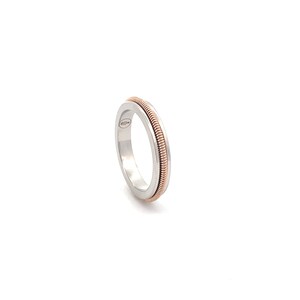 May include: A silver ring with a thin band of rose gold wrapped around it.