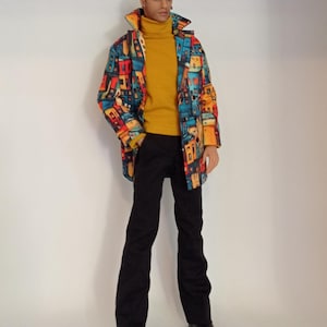 May include: A fashion doll wearing a mustard yellow turtleneck sweater, black trousers, and a long coat featuring a vibrant, multi-colored abstract city print. The doll has short brown hair and is wearing black shoes. The text RPoutfitsdolls is visible.