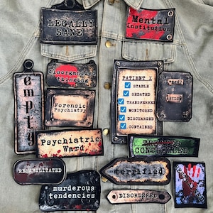 May include: A collection of distressed-style patches with text related to mental health and institutions. The patches feature phrases like "Legally Sane," "Mental Institution," "Psychiatric Ward," and "Patient X." The color palette includes black, red, and white.