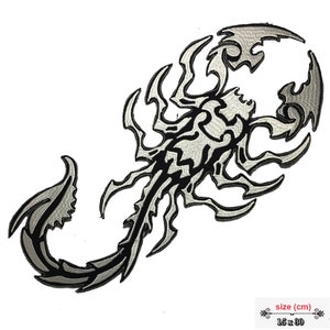 May include: A silver and black embroidered scorpion patch with a tribal design. The patch measures 15 x 80 cm.