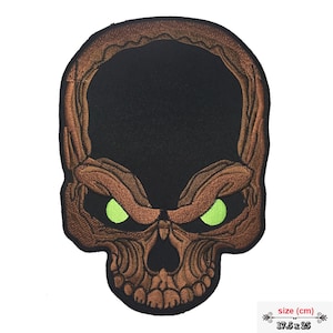 May include: A brown embroidered skull patch with green glowing eyes. The patch is 17.5 inches by 25 inches.