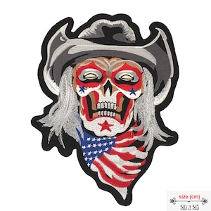 May include: Embroidered iron-on patch featuring a skull wearing a cowboy hat and bandana with an American flag design. The skull has red, white, and blue stars on its face. The patch is 20 x 26 cm.
